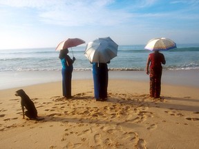 Three Sri Lankan ladies and umbrellas. Beach scene/Mirissa.