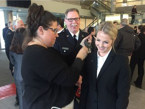 Const. Madison McCardell, being mic'd-up by Postmedia News videographer Niki Bennett, with her father, Insp. Jim McCardell, at a swearing-in ceremony for the Vancouver Police Department on Jan. 4. Madison became the third generation in her family to join the VPD.