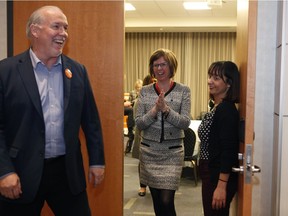 New Nanaimo MLA Shiela Malcolmson, centre, is joined by Premier John Horgan after winning the byelection on Wednesday, Jan. 30, 2019.