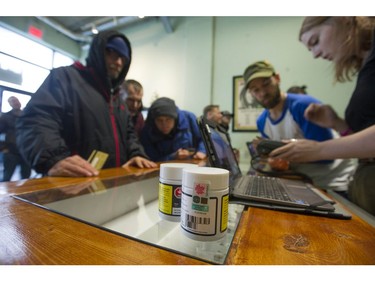 Vancouver, BC's first licensed pot shop, Evergreen Cannabis Society on W. 4th Avenue, officially opens its doors to paying customer Saturday, January 5, 2019. Pictured are the first customers buying cannabis products.