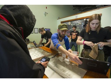 Vancouver, BC's first licensed pot shop, Evergreen Cannabis Society on W. 4th Avenue, officially opens its doors to paying customer Saturday, January 5, 2019. Pictured are the first customers buying cannabis products.