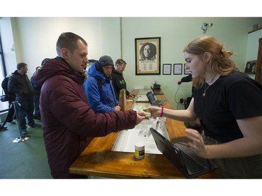 Vancouver, BC's first licensed pot shop, Evergreen Cannabis Society on W. 4th Avenue, officially opens its doors to paying customer Saturday, January 5, 2019. Pictured are the first customers buying cannabis products.