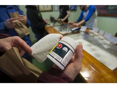 Vancouver, BC's first licensed pot shop, Evergreen Cannabis Society on W. 4th Avenue, officially opens its doors to paying customer Saturday, January 5, 2019. Pictured are the first customers buying cannabis products.