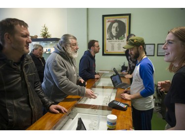 Vancouver, BC's first licensed pot shop, Evergreen Cannabis Society on W. 4th Avenue, officially opens its doors to paying customer Saturday, January 5, 2019. Pictured are the first customers buying cannabis products.