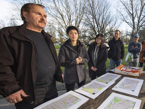 Al MacLellan (left) and Grace Chen of Second Chance in Life Foundation at a rally at Trout Lake Park in East Vancouver recently, raising awareness for a missing rescued dog named Roxy. About 25 volunteers showed up to do a grid search for the missing dog, rescued from Korea before it could wind up on a menu.