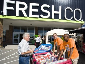 Ten Safeway locations in B.C. will re-open as discount grocery FreshCo later this year as part of the stores expansion into Western Canada. A shopper and staff members are pictured outside a FreshCo location in Niagara, Ont., in this 2011 file photo.