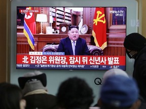 People in Seoul watch a TV newscast showing North Korean leader Kim Jong Un's New Year's speech on Jan. 1.