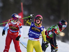 Germany's Heidi Zacher gestures on winning after a tight race, in front of Marielle Thompson of Canada, right, and Fanny Smith of Switzerland, left, during the women's final FIS Freestyle Ski Cross World Cup event in Idre, Sweden, Saturday Jan. 19. 2019.