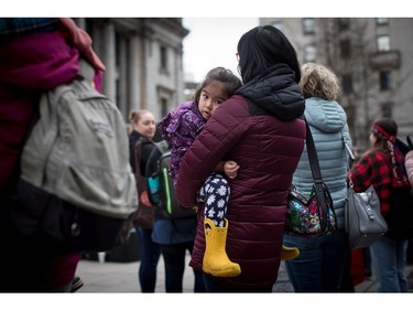 Michiko Lee, 4, is held by her mother Andrea Lee while attending the third annual Women's March in Vancouver, on Saturday January 19, 2019.