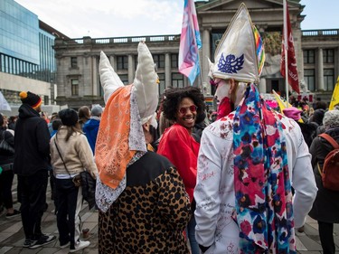 Julian Grandberry, back centre, stops to talk with people in costume while dancing during the third annual Women's March in Vancouver, on Saturday January 19, 2019.