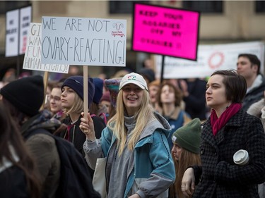 A woman holds a sign during the third annual Women's March in Vancouver, on Saturday January 19, 2019.