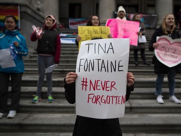 A young woman holds a sign bearing Tina Fontaine's name during the third annual Women's March in Vancouver, on Saturday January 19, 2019. The remains of Fontaine, a 15-year-old Indigenous girl, were found in Winnipeg's Red River eight days after she was reported missing in 2014.