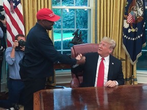 (Files) in this file photo US President Donald Trump meets with rapper Kanye West in the Oval Office of the White House in Washington, DC, October 11, 2018. - Rapper Kanye West, who has been outspoken in his support for President Donald Trump, now says he's going to focus on his music and fashion after being "used" in the world of politics, October 30, 2018.
