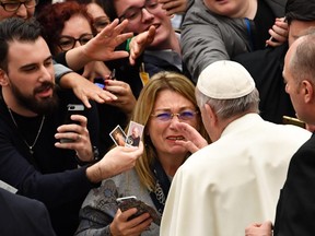 Pope Francis blesses a woman at the end of the weekly general audience on January 9, 2019 at Paul-VI hall in the Vatican.