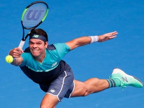 Canada's Milos Raonic hits a return against Switzerland's Stanislas Wawrinka during their men's singles match on day four of the Australian Open tennis tournament in Melbourne on January 17, 2019.