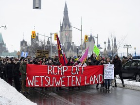 Protesters voice their opposition against pipelines as they block traffic in front of the Prime Ministers Offices in downtown Ottawa on Tuesday, Jan. 8, 2019.