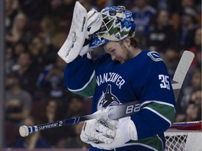 Vancouver Canucks' netminder Thatcher Demko adjusts his mask during Friday's NHL action against the Buffalo Sabres at Rogers Arena. The Canucks won 4-3.
