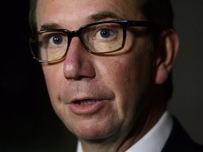 Scott Brison speaks in the foyer of the House of Commons on Parliament Hill in Ottawa on Wednesday, Sept. 19, 2018.