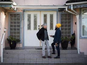 NDP Leader Jagmeet Singh right) speaks with Paul Pelletreau while door knocking for his byelection campaign, in Burnaby on Jan. 12, 2019.