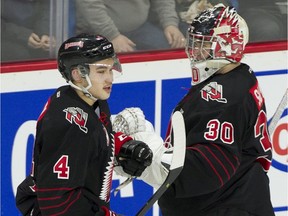 Moose Jaw Warriors Jett Woo taps gloves with goalie Brodan Salmond after scoring on the Vancouver Giants in the first period at the LEC on Saturday.