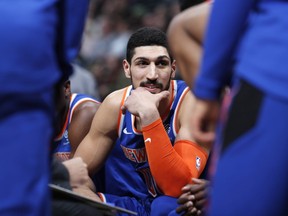 In this Jan. 1, 2019, file photo, New York Knicks centre Enes Kanter jokes with teammates during a timeout the first half of the team's NBA basketball game against the Denver Nuggets, in Denver.
