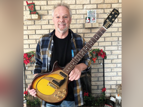 April Wine's Myles Goodwyn holds his 1962 Gibson Melody Maker, which was stolen in 1972.