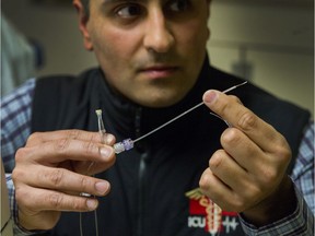 Dr. Mypinder Sekhon demonstrates catheters and the new brain bolt that were used in a life-saving procedure at VGH in Vancouver, BC, Jan. 16, 2019.