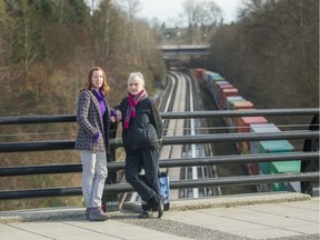 Jane Henry (left) and Linda Fox at the rail-line overpass at Lakewood Drive near North Grandview Highway. Fox has been suffered from sleep deprivation since CN reactivated the line.