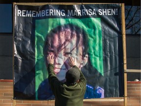 A protester puts up a poster on Tuesday outside Vancouver provincial court of 13-year-old Marrisa Shen, who was killed in July 2017.