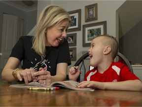 Katie Welsh and her son Charlie colour at the kitchen table. Katie's was Canada's first Paediatric heart transplant patient and has received a second transplant heart.