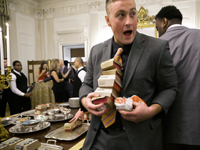 Guests attending a reception for the Clemson Tigers grab burgers in the State Dining Room of the White House, Jan. 14, 2019.