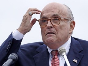 In this Aug. 1, 2018 file photo, Rudy Giuliani, an attorney for President Donald Trump, addresses a gathering during a campaign event fin Portsmouth, N.H. Giuliani says he's never said there was no collusion between Russia and members of the Trump campaign. Giuliani's comments Wednesday night on CNN directly contradict the position of his own client, who has repeatedly insisted that there was no collusion during his successful 2016 presidential campaign. Giuliani himself has described the idea of Russian collusion as "total fake news."