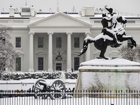 Snow blankets a statue of Andrew Jackson in Lafayette Square with the White House behind, as a winter storm arrives in the region, Sunday, Jan. 13, 2019, in Washington. (AP Photo/Alex Brandon)