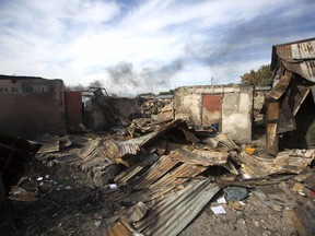 In this Nov. 21, 2018 photo, homes that were burned to the ground during a massacre lay in ruins in the La Saline slum of Port-au-Prince, Haiti. Around three in the afternoon on November 13th, men in police uniforms entered the neighborhood, going house to house, pulling unarmed people into the narrow alleys and executing them with single shots.