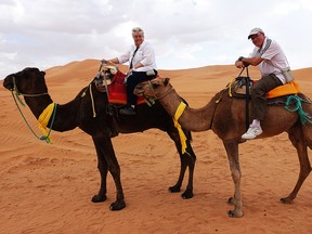 Donna McCormick and her husband ride camels over the Erg Chebbi Dunes.