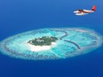 Sea plane flying above Maldives islands, Raa atol.