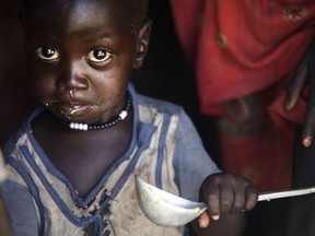 Boy eats from ladle at his home in Ngop in South Sudan. The world's youngest nation, formed after splitting from the north in 2011, has declared famine in parts of Unity State.