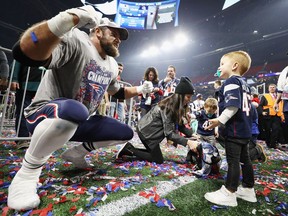 James Develin of the New England Patriots celebrates with his son William Robert Develin after winning Super Bowl 53 against the Los Angeles Rams at Mercedes-Benz Stadium on Feb. 3 in Atlanta, Ga.