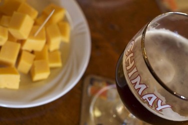 A Chimay Trappist beer and a snack of cubed cheese inside A La Mort Subite, Brussels.