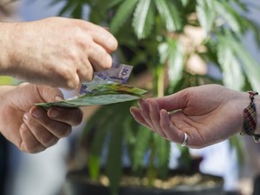 Money changes hands at a vendor in the market of the annual 420 marijuana event at its new location, Sunset Beach, Vancouver April 20 2016.