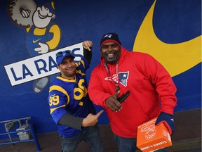 L.A. Rams fan Joey Andrade, left, trash talks New England Patriots' fan Keandre Devina outside the iconic Randy's Donuts Inglewood store on Friday.