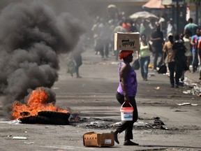 A tire placed by a small group of demonstrators burns on a street in the commune of Petion Ville in the Haitan capital of Port-au-Prince on Sunday, Feb. 17, 2019.