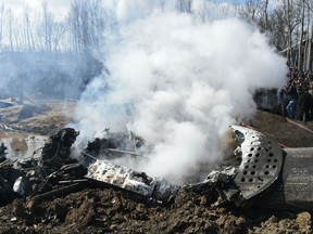 Smokes billows from the remains of an Indian Air Force helicopter after it crashed in Budgam district, on the outskirts of Srinagar on Feb. 27, 2019.