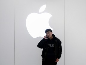 A Chinese man is on the phone outside the Apple Store on January 3, 2019 in Beijing, China.