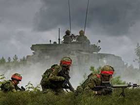 Simulated opposing forces attack a defensive position occupied by members of the Canadian Army Reserve, 4th Canadian Division, during Exercise STALWART GUARDIAN on August 26, 2015 at Garrison Petawawa, Ontario.