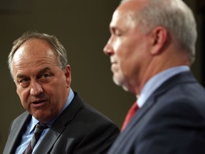 Green Party Leader Andrew Weaver, left, says he wants to distance himself from Premier John Horgan and the NDP agenda after his party's byelection spanking in Nanaimo, but so far he and his Green colleagues have voted to support the government.