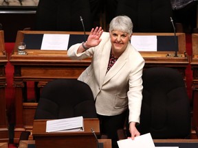 Finance Minister Carole James arrives to deliver the budget speech as she waves to people in the gallery at the legislature in Victoria, B.C., on Tuesday, February 19, 2018.