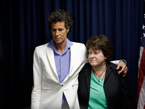 In this April 26, 2018, file photo, Bill Cosby accuser Andrea Constand, left, and her attorney Dolores Troiani listen during a news conference after Cosby was found guilty in his sexual assault trial, in Norristown, Pa.
