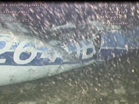 In this image released Monday Feb. 4, 2019, by the UK Air Accidents Investigation Branch (AAIB) showing the rear left side of the fuselage including part of the aircraft registration N264DB that went missing carrying soccer player Emiliano Sala, when it disappeared from radar contact on Jan. 21 2019. The Air accident investigators say one body is visible in the sea in the wreckage of the plane that went missing carrying soccer player Emiliano Sala and his pilot David Ibbotson.