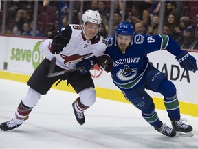 Vancouver Canucks Tyler Motte and Arizona Coyotes Jakob Chychrun chase the puck in the first period of a playoff push for both teams.